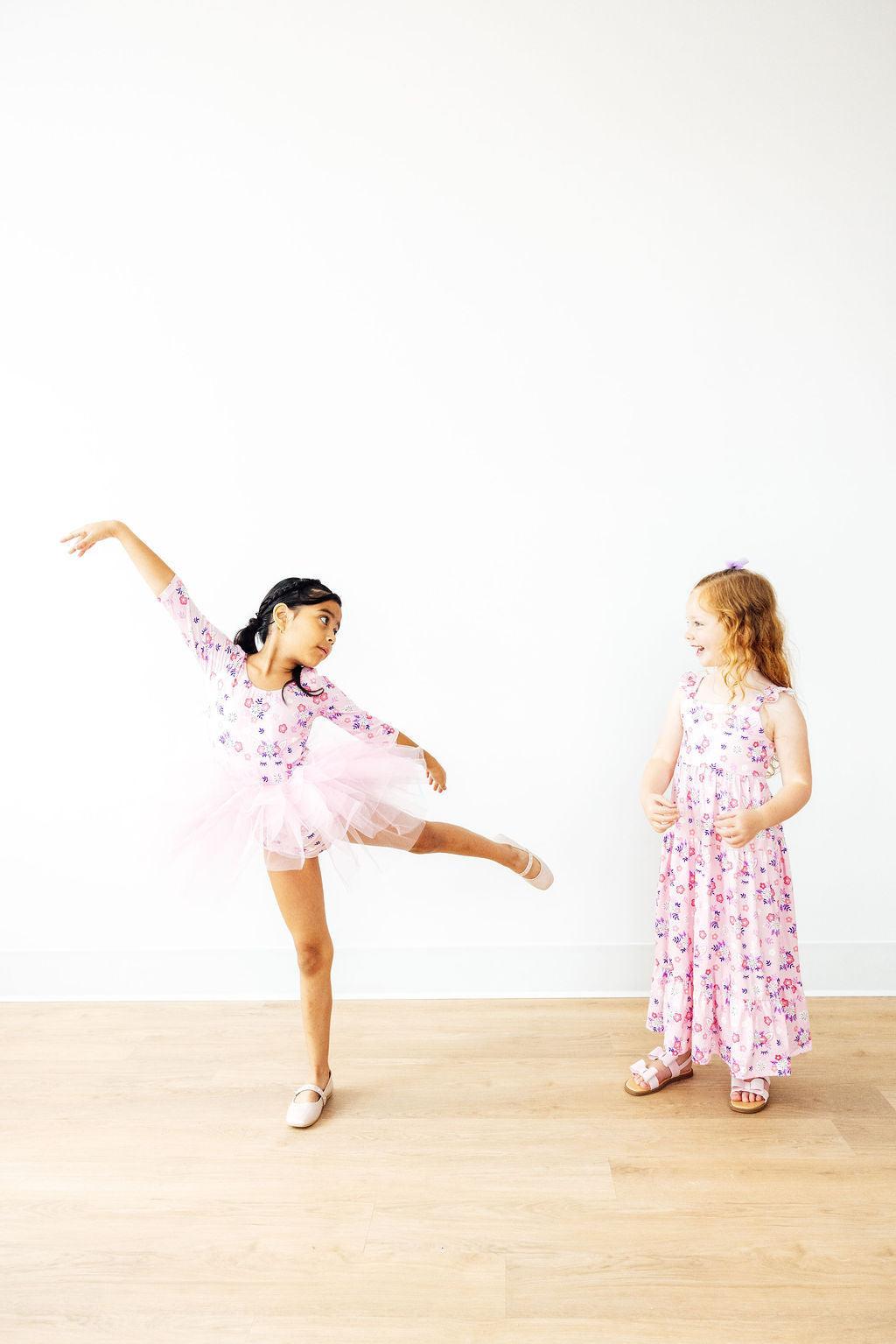 a girl in pink dress and a girl in pink dress