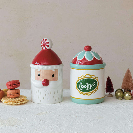 a couple of ceramic jars with cookies and trees