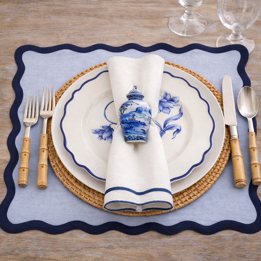 a plate with a napkin and silverware on a place mat
