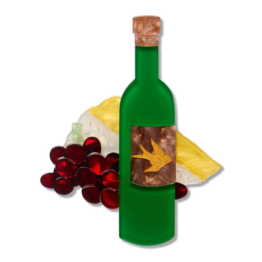 a green bottle with a gold bird on it