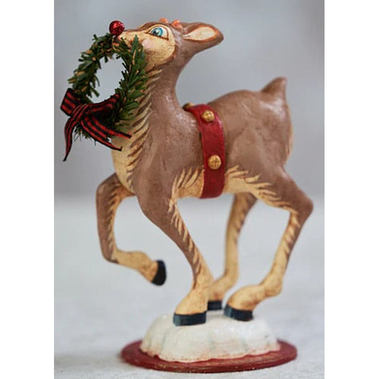 a statue of a reindeer holding a wreath