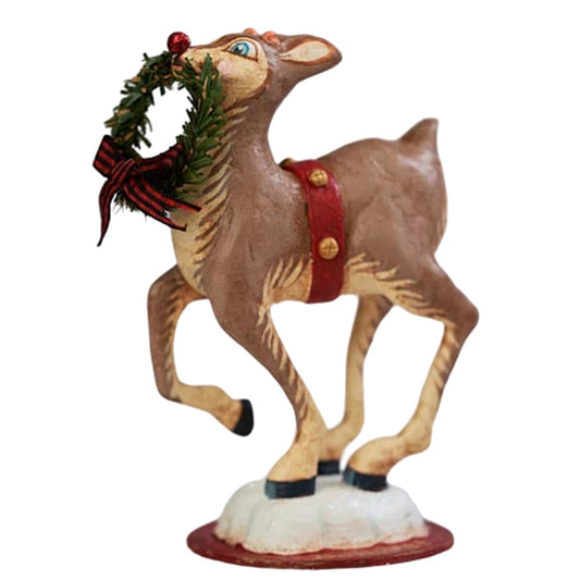 a statue of a reindeer holding a wreath