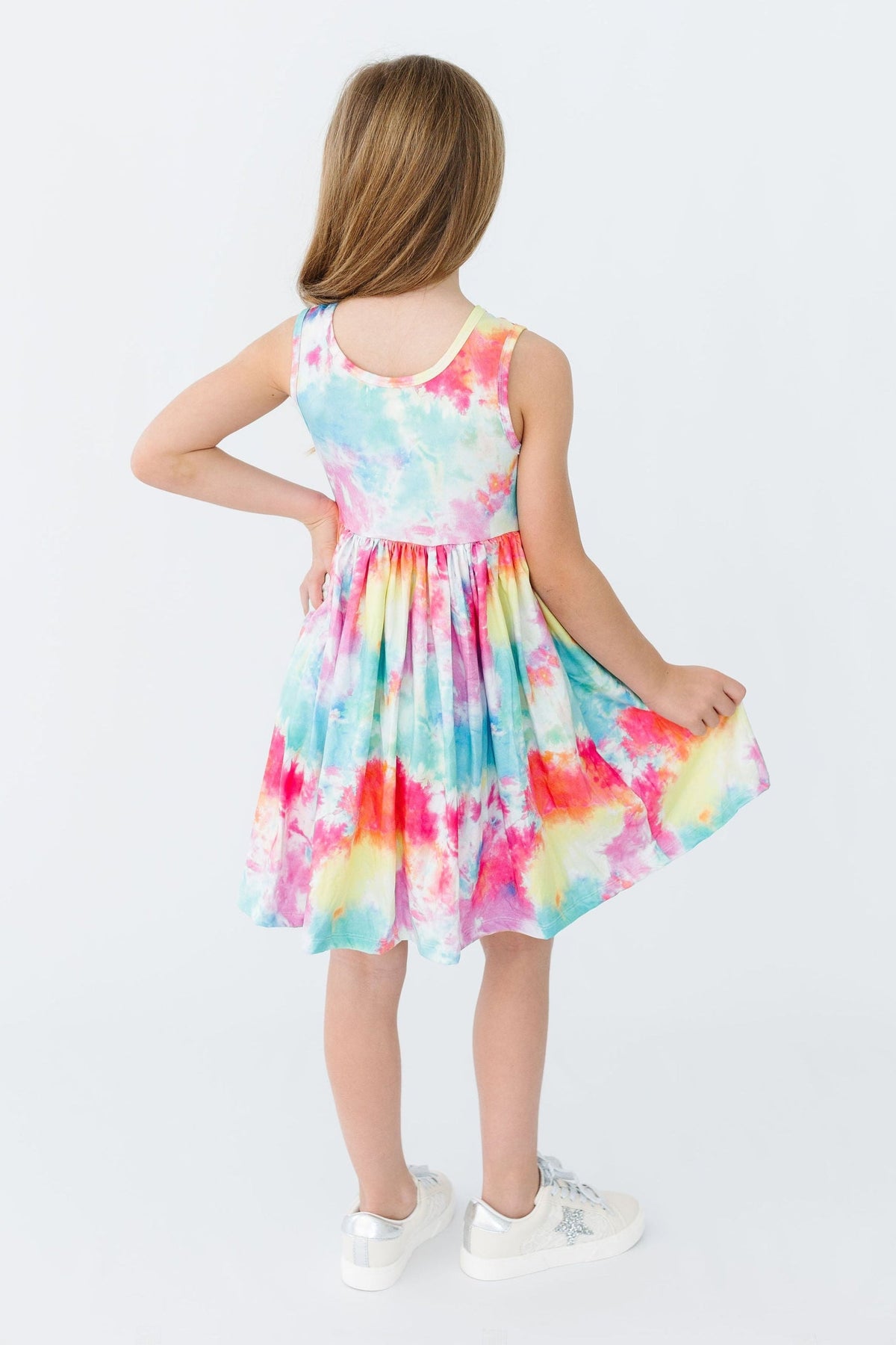 a girl in a tie dye dress