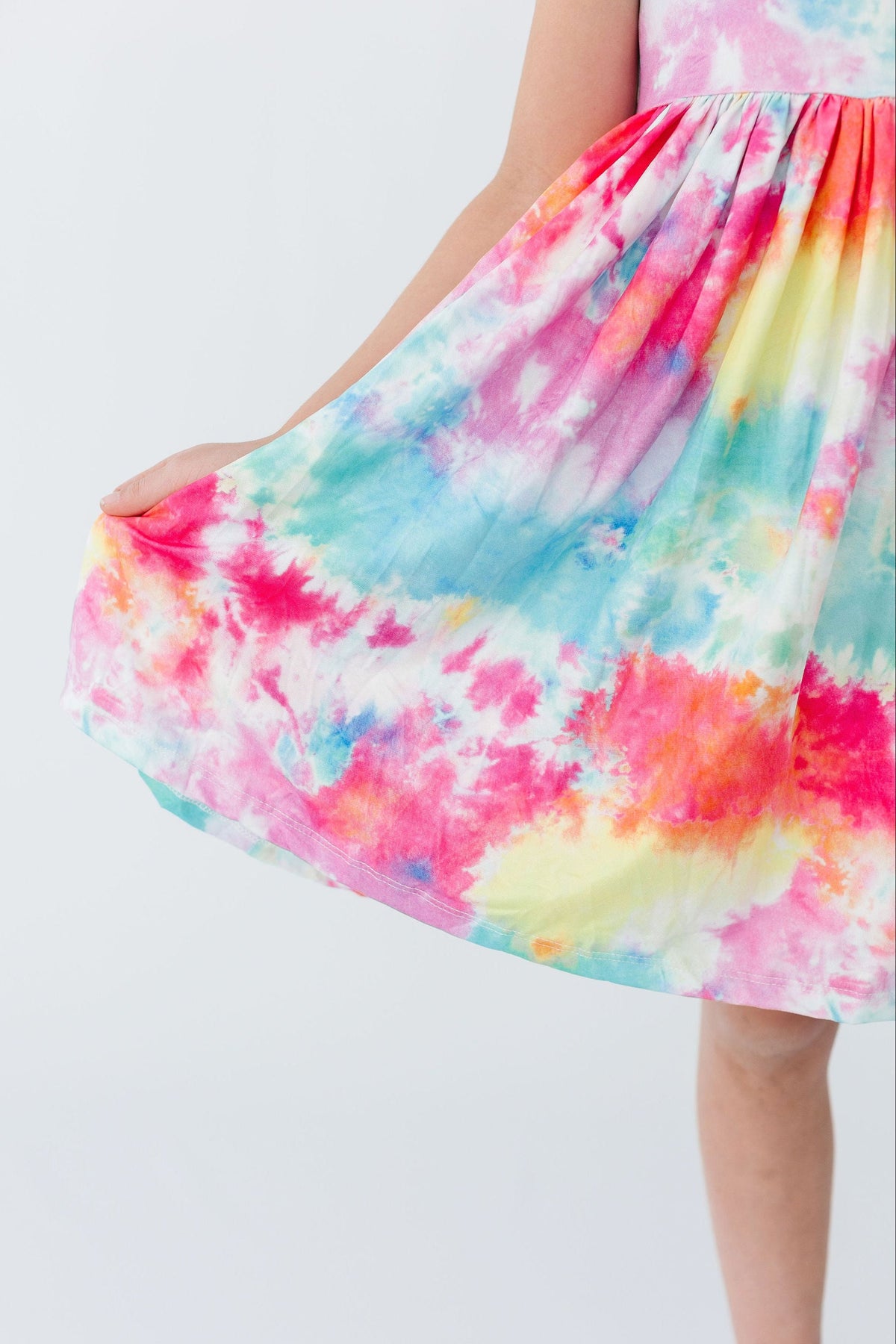 a girl wearing a tie dye dress