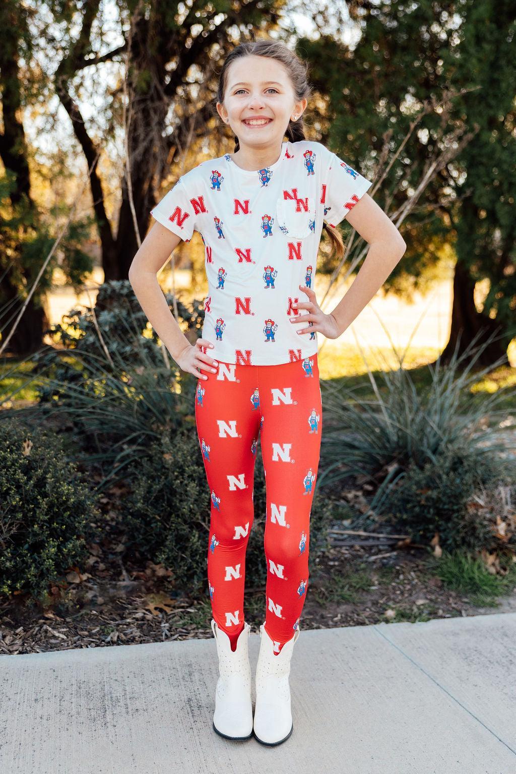 a girl standing on a sidewalk