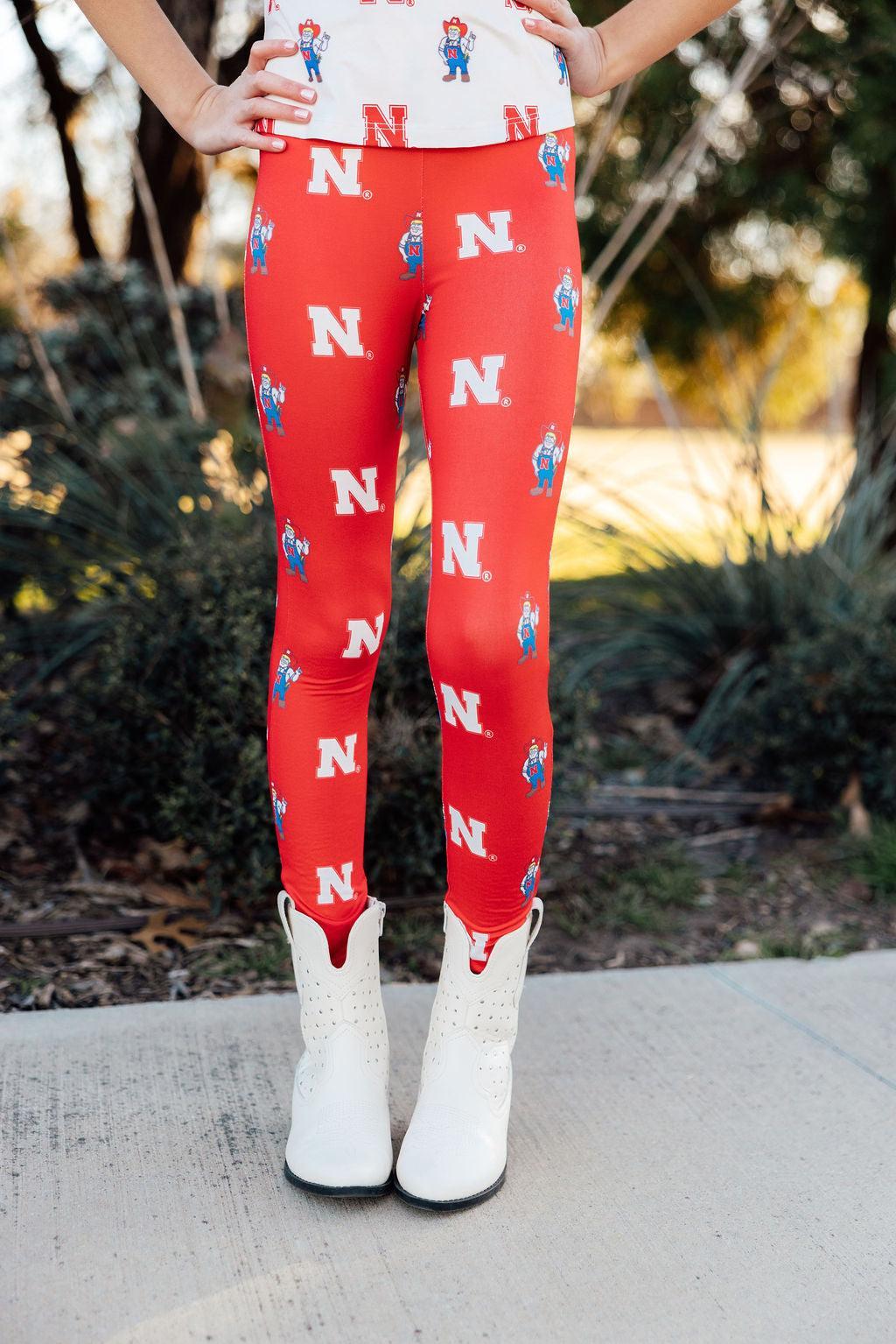 a person wearing red tights with white boots