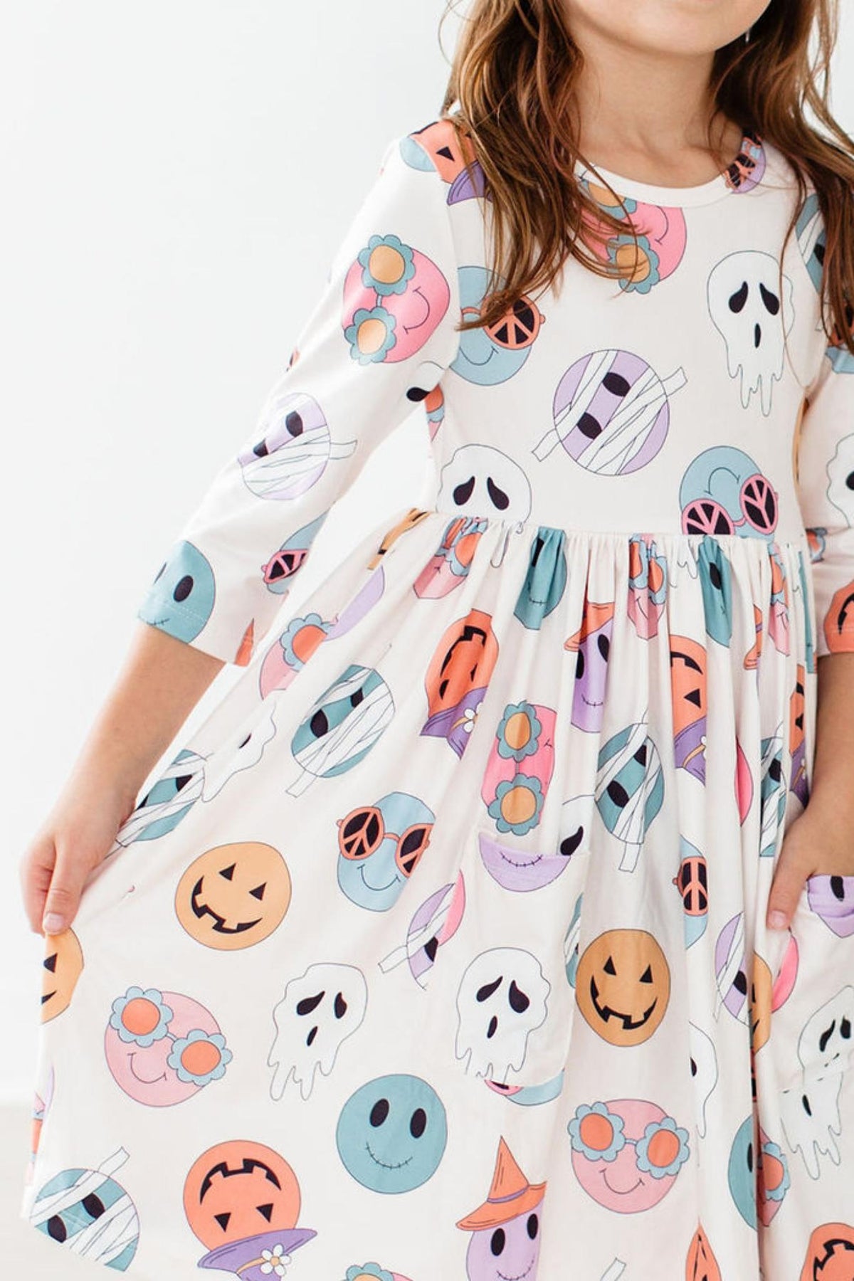 a girl wearing a dress with a pattern on it