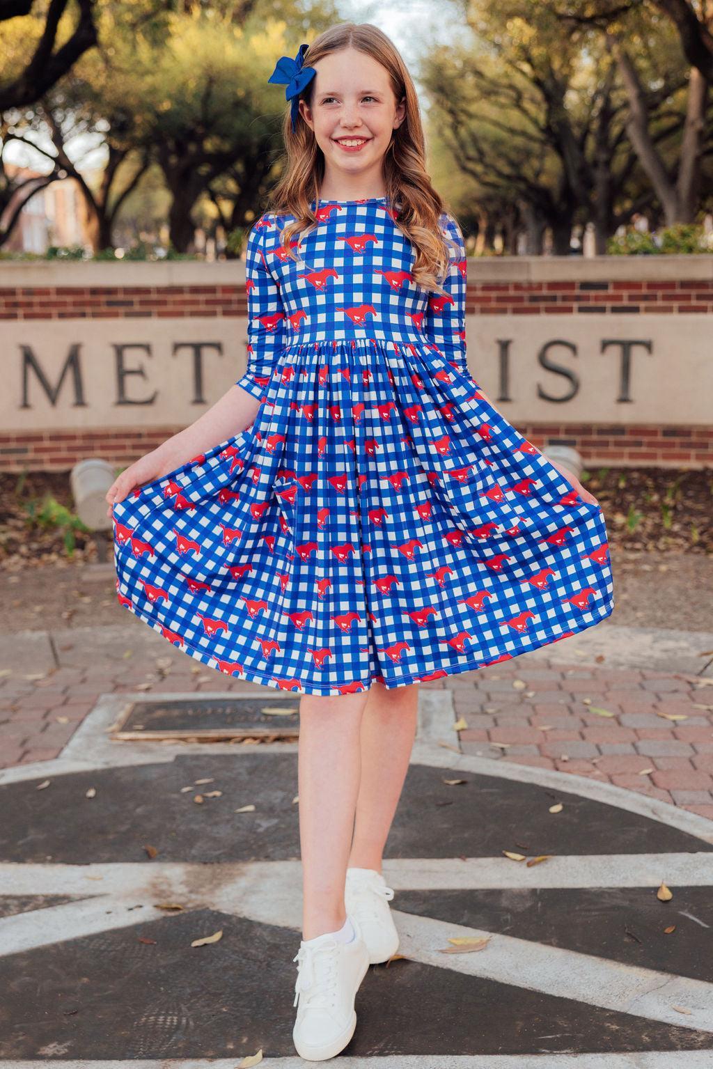 a girl in a blue and white checkered dress