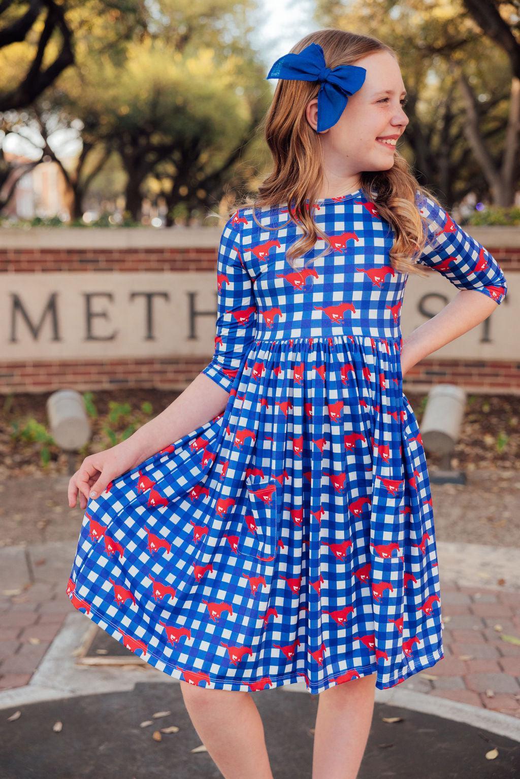 a girl in a blue and white checkered dress