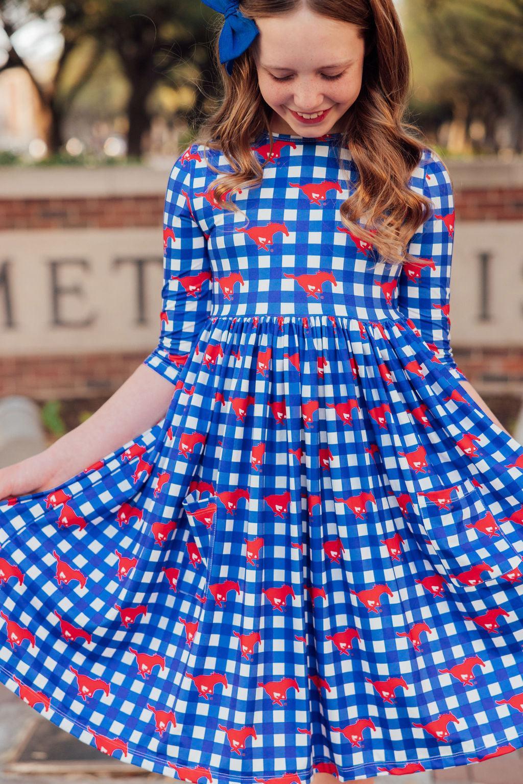 a girl in a blue and white checkered dress