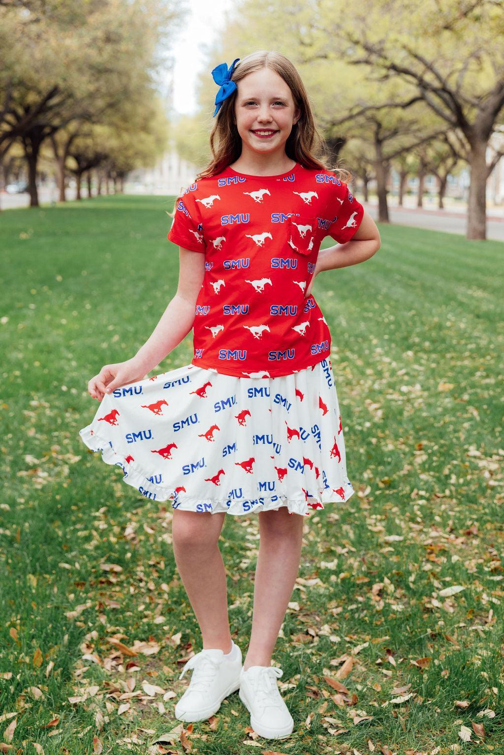a girl in a red shirt and white skirt