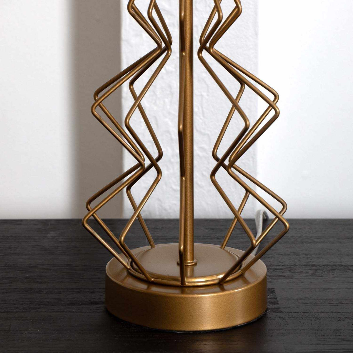 a gold object on a black surface