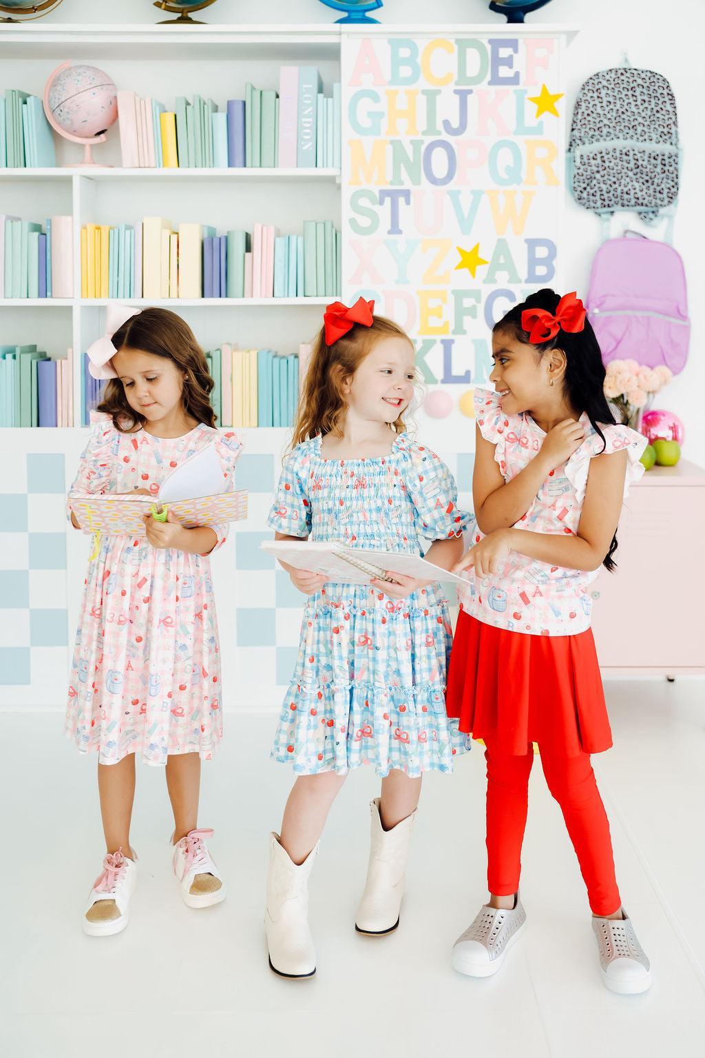a group of girls in dresses