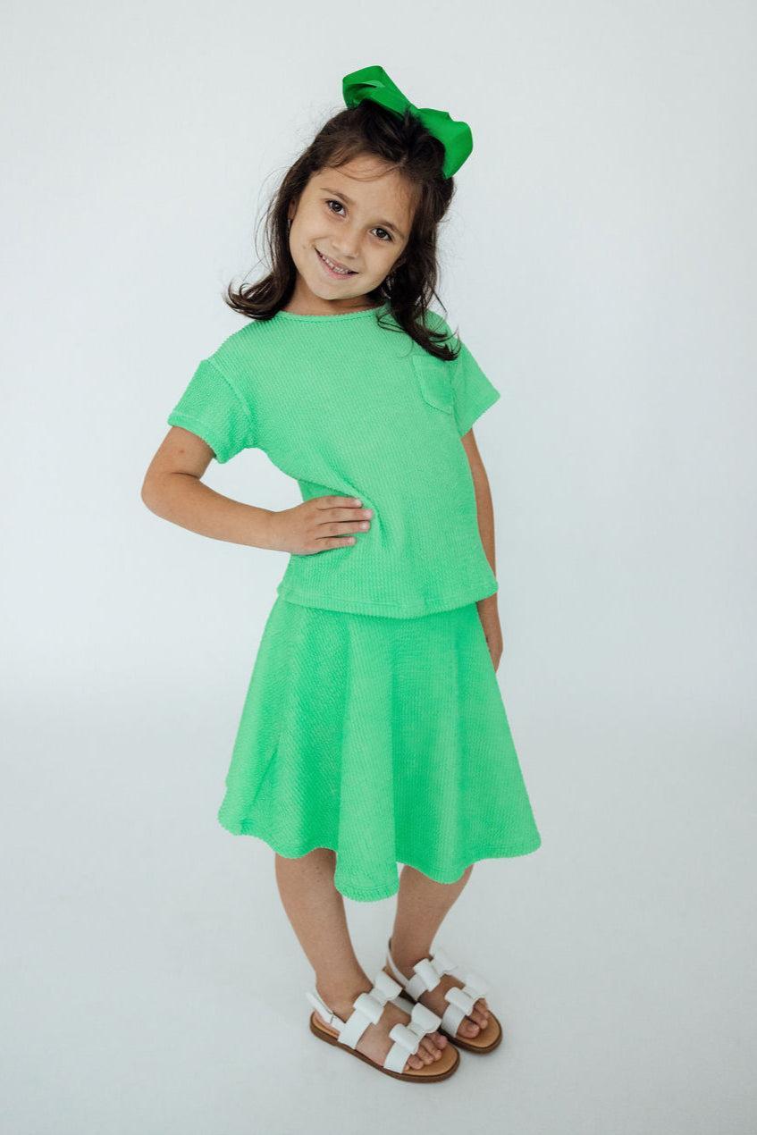 a girl in a green dress
