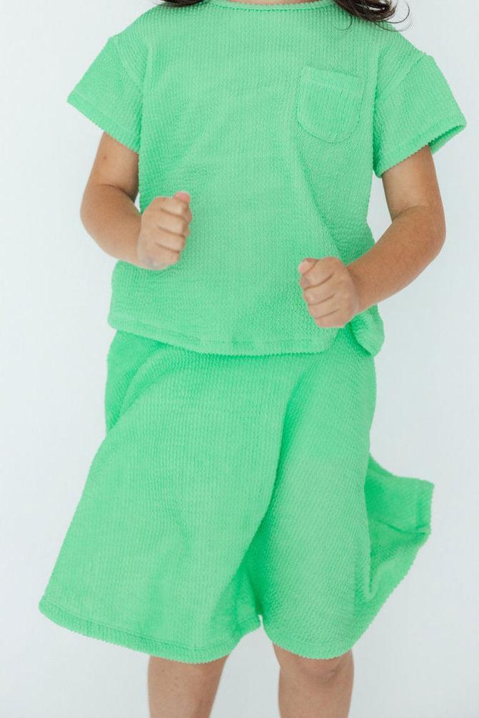 a girl in a green outfit