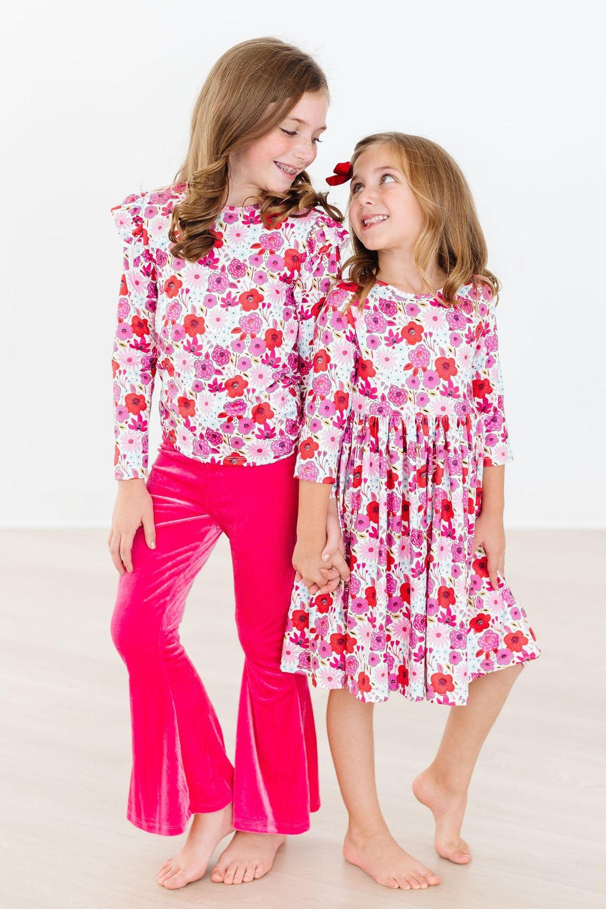 two girls in pink and white outfits