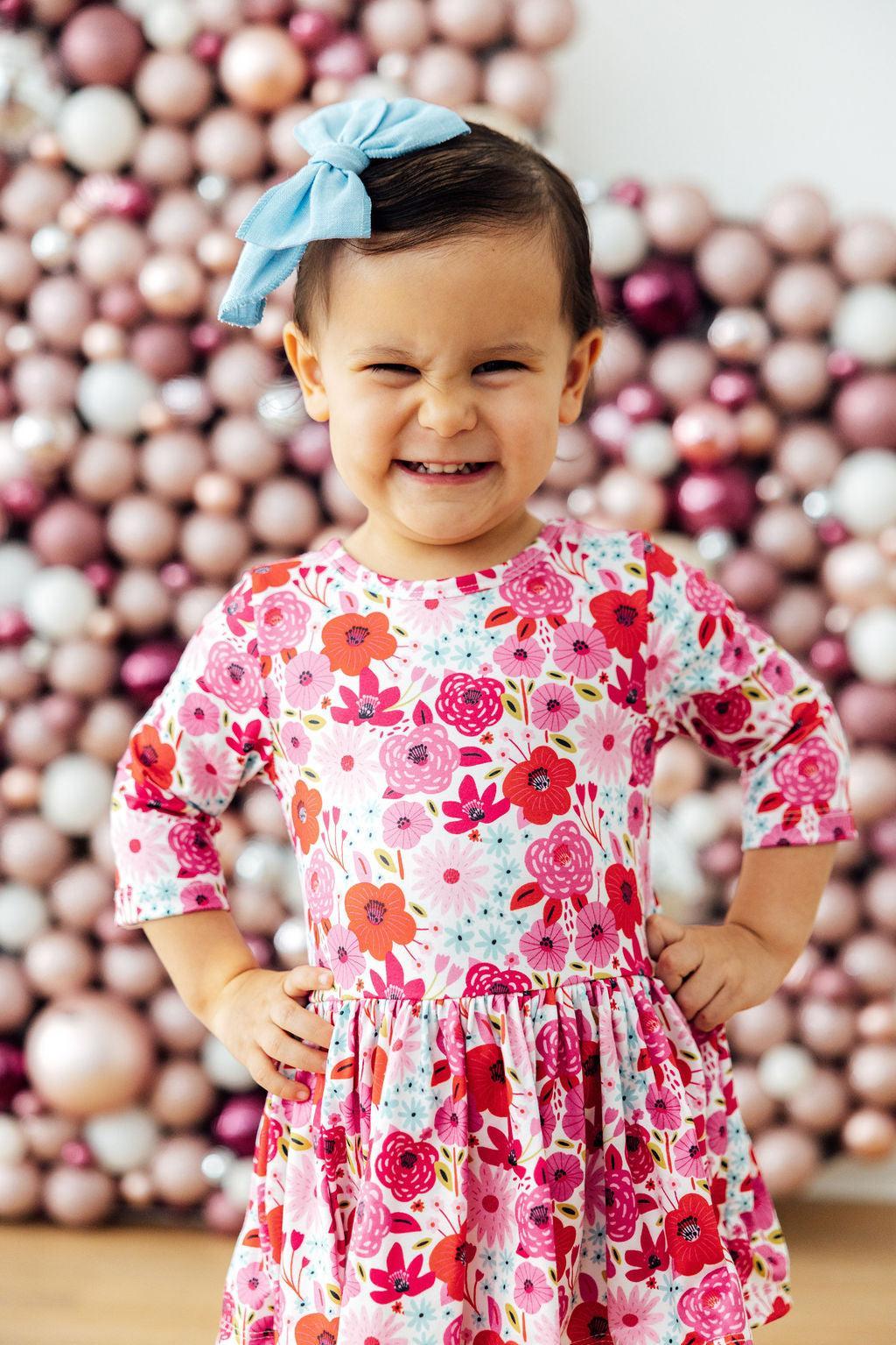 a girl in a dress with a bow on her head
