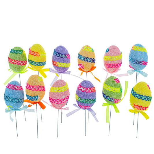 a group of colorful eggs on sticks
