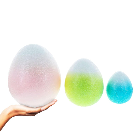 a hand holding a set of eggs