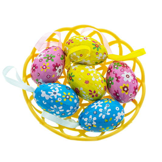 a group of colorful eggs in a yellow basket