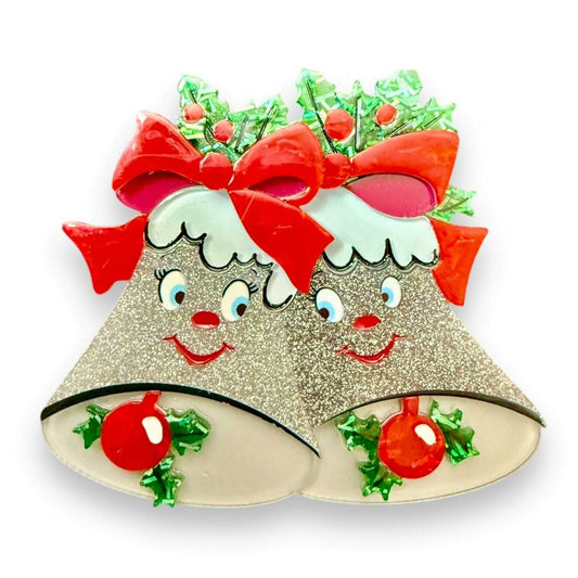 a silver bells with red bows and green leaves