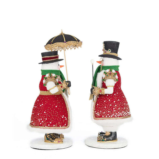 two snowmen holding an umbrella