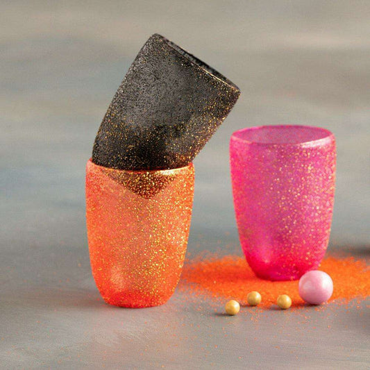 a couple of glasses with glitter