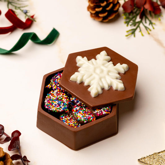 a chocolate box with sprinkles and candy