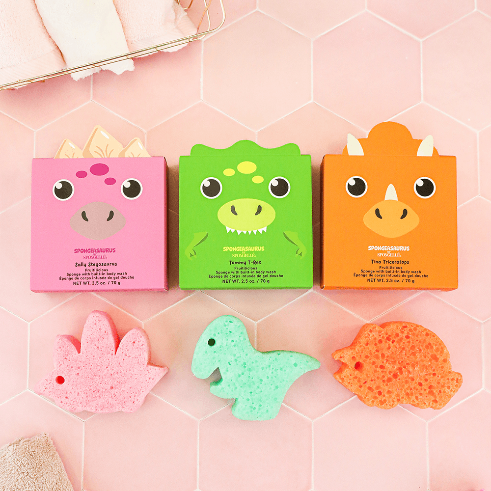 a group of colorful objects on a pink tile surface