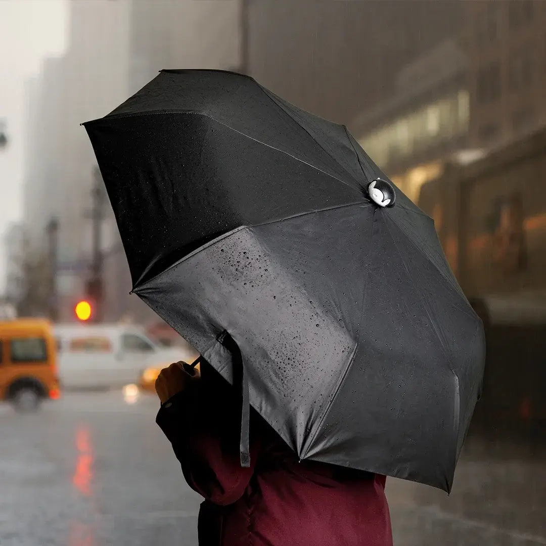 a person holding an umbrella in the rain