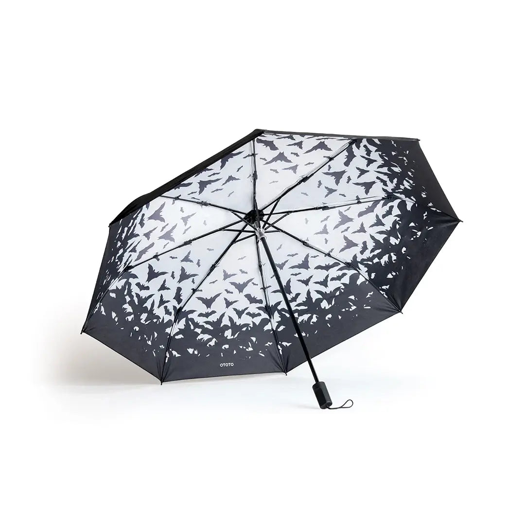 a black and white umbrella with birds on it
