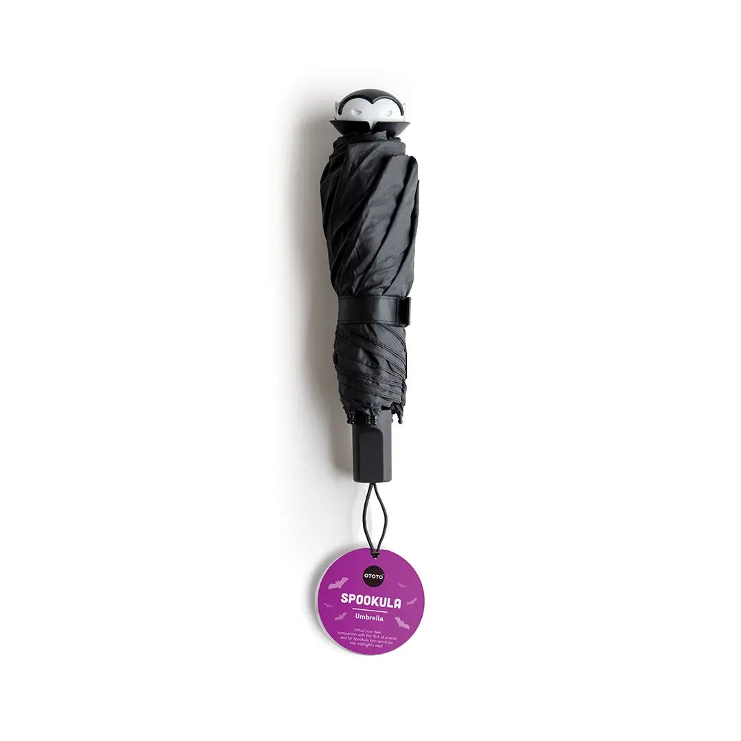 a black umbrella with a purple label