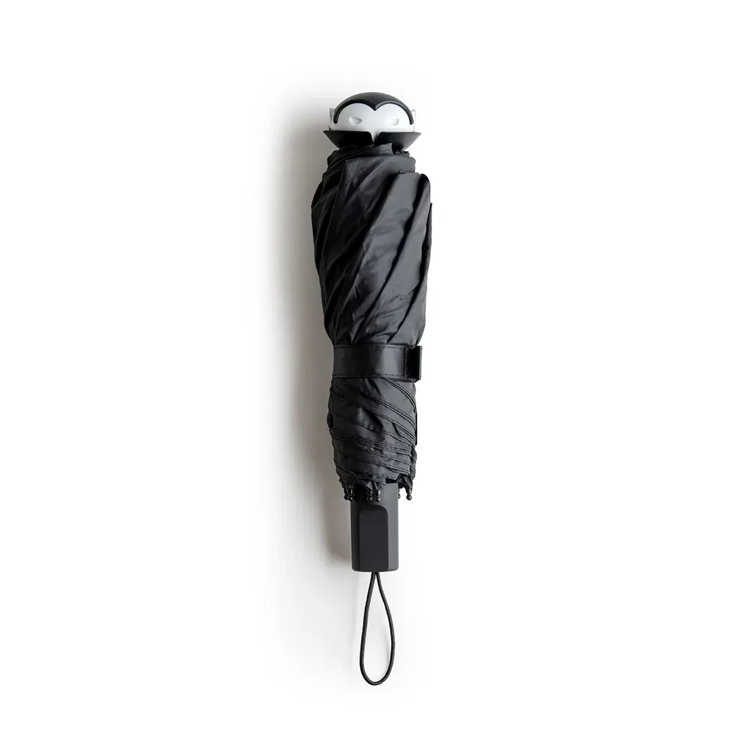 a black umbrella with a penguin face