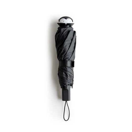 a black umbrella with a penguin face