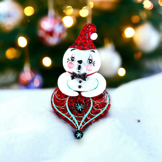 a snowman ornament on snow