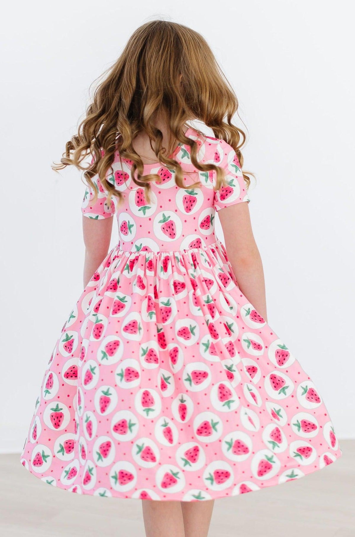 a girl in a pink dress