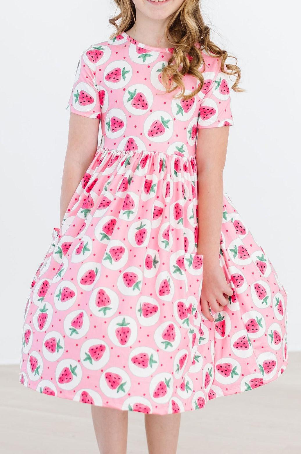a girl in a pink dress