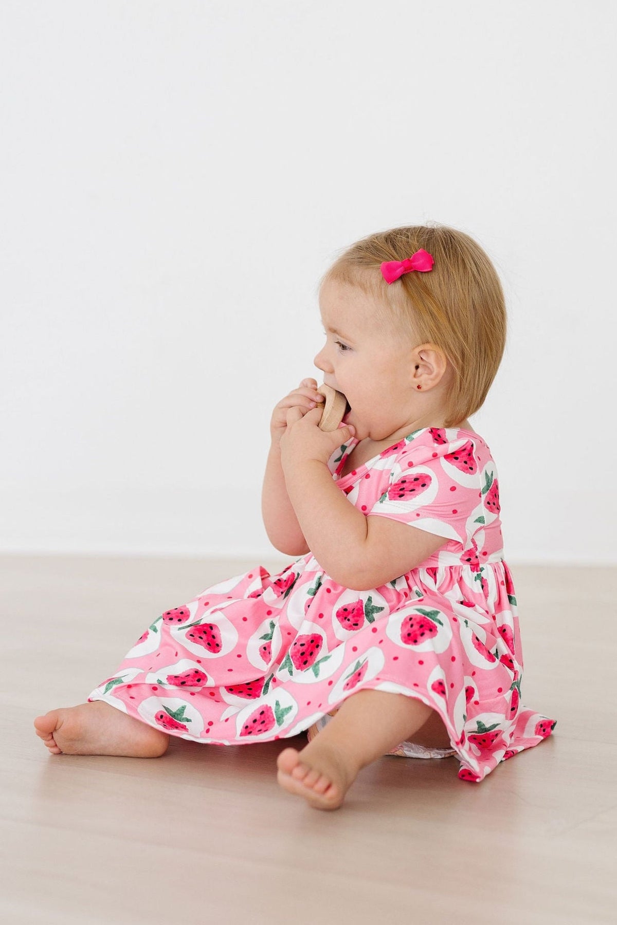 a girl in a pink dress eating
