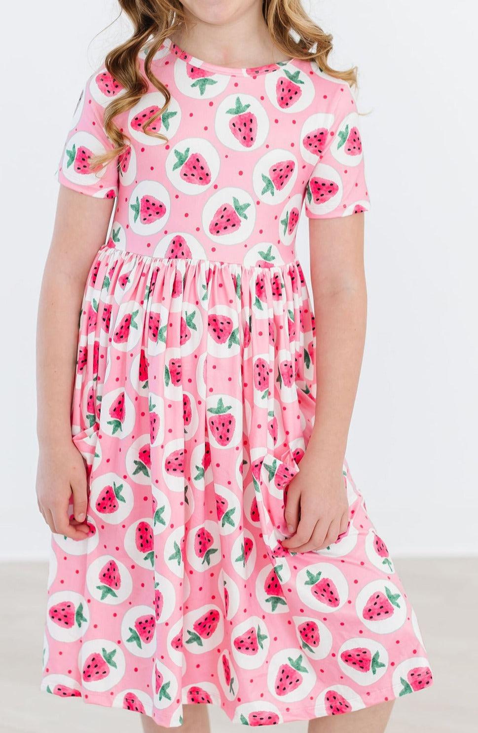 a girl in a pink dress