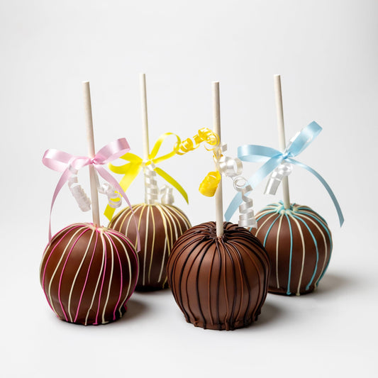 a group of chocolate apples with ribbons
