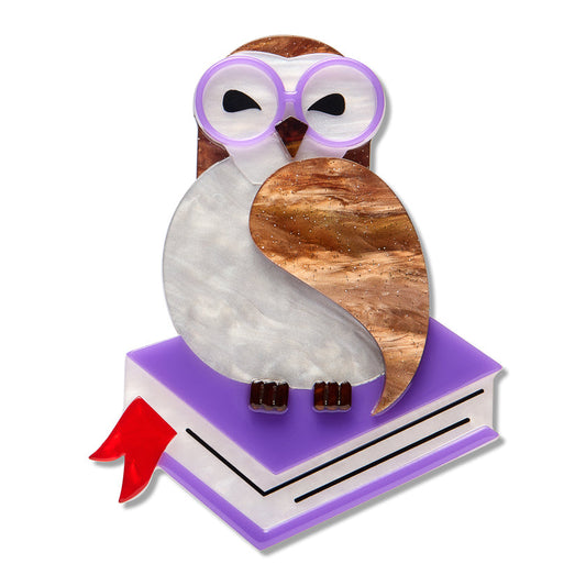 an owl figurine on a book