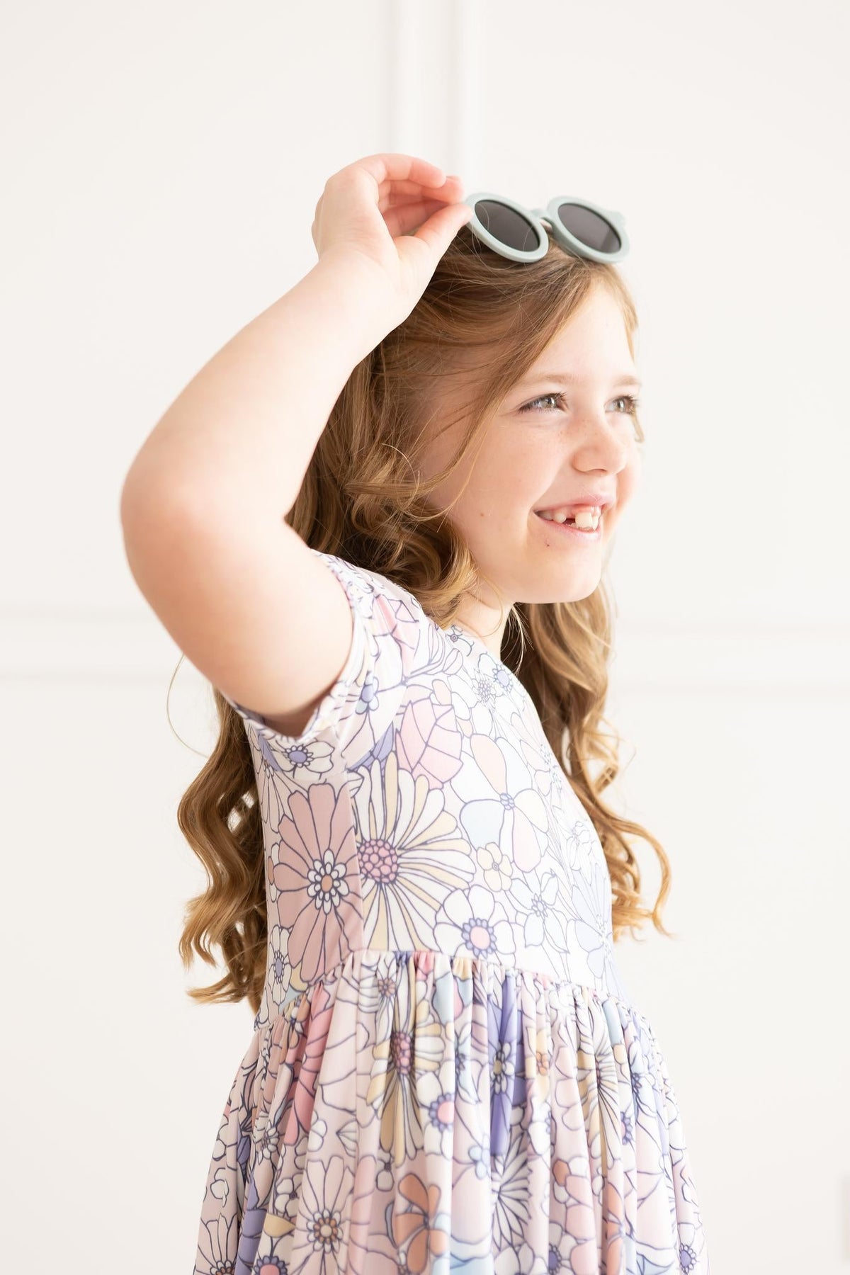 a girl wearing sunglasses and smiling