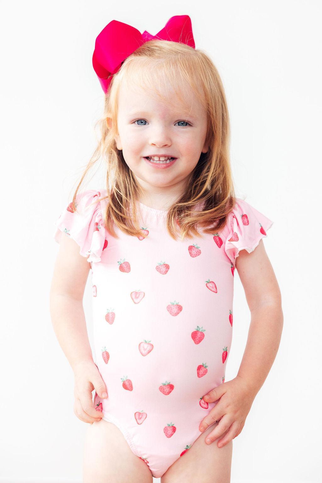 a girl wearing a pink dress