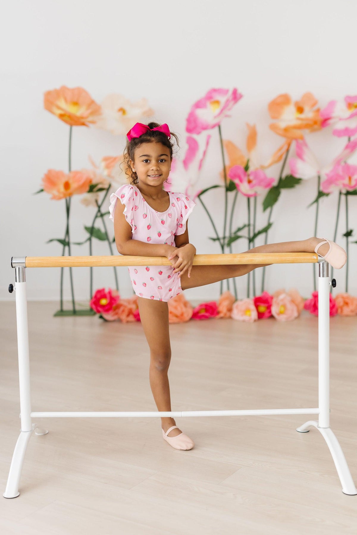 a girl in pink dress and ballet shoes