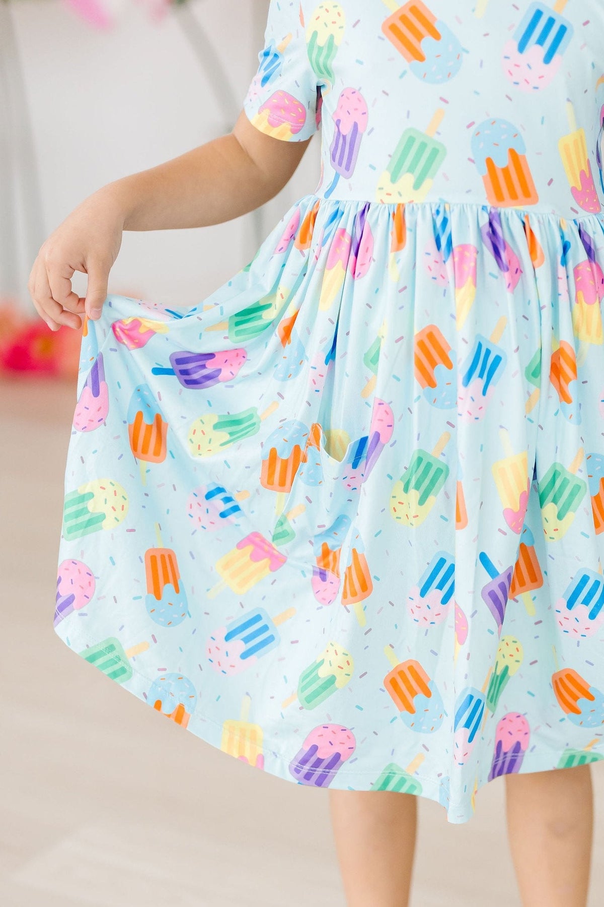 a girl wearing a dress with ice cream on it