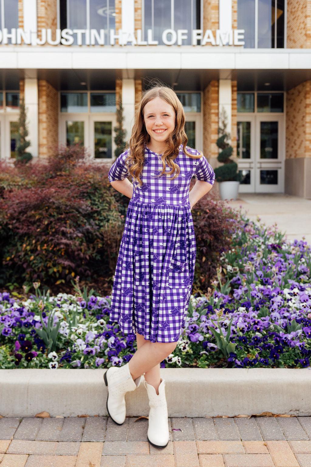a girl in a purple dress