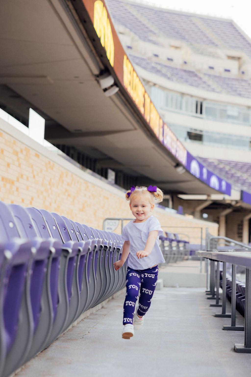 a girl running in a stadium