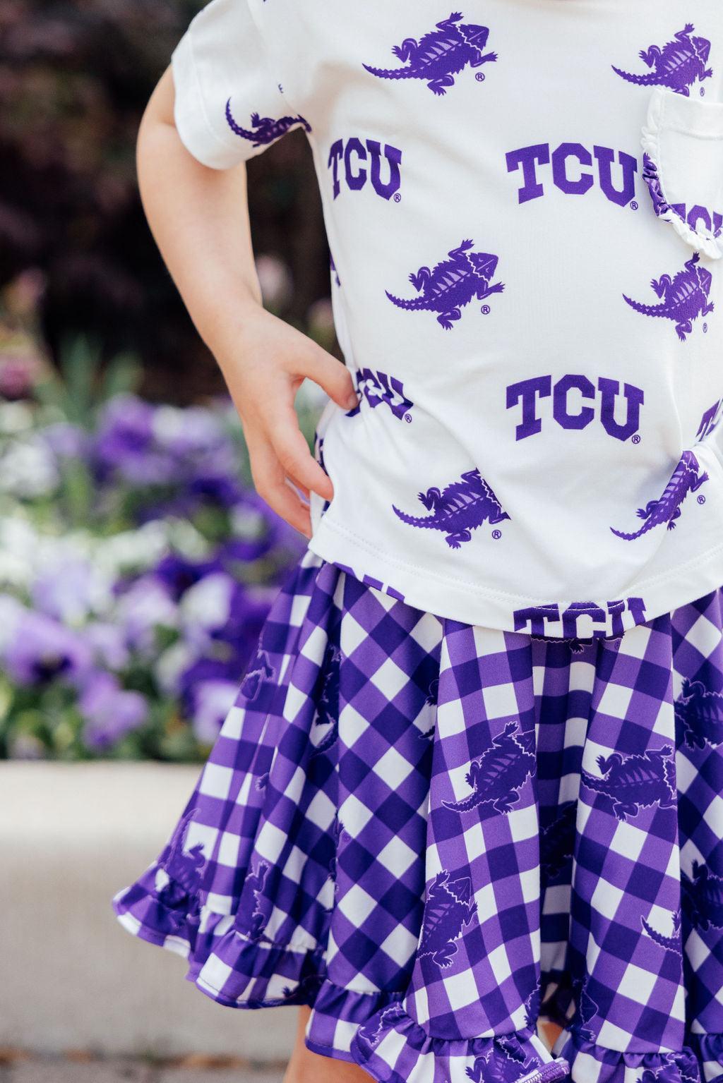 a child wearing a purple and white shirt