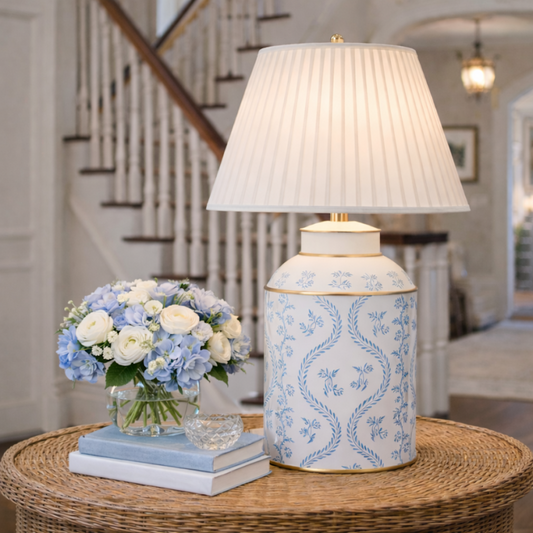 a vase of flowers and a lamp on a table