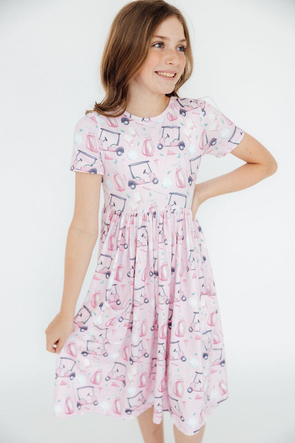 a girl in a pink dress